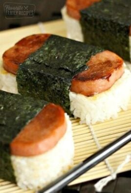 Spam Musubi, rice and spam wrapped in seaweed, on a bamboo sheet