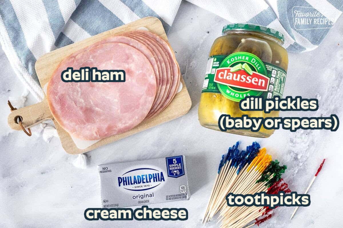 Ingredients for Ham Roll Ups with Pickle including ham, pickles, cream cheese and toothpicks.