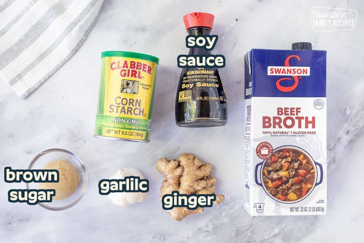 Ingredients for Beef Stir Fry Marinade including soy sauce, beef broth, corn starch, brown sugar, garlic and ginger.