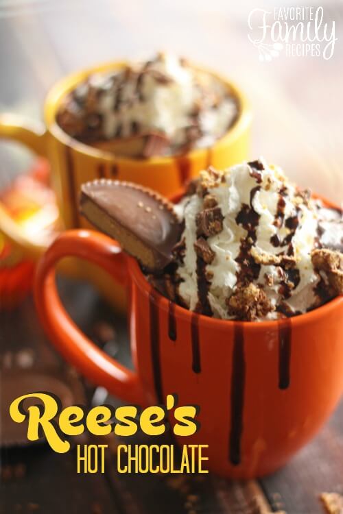 Reese's hot chocolate in an orange mug with chocolate drizzled over top.