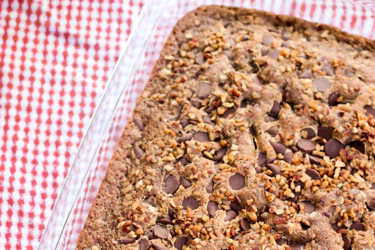 Picnic cake in a 9x13 inch pan sitting on a picnic blanket.