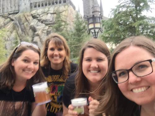 Sisters at the Wizarding World of Harry Potter drinking butterbeer.