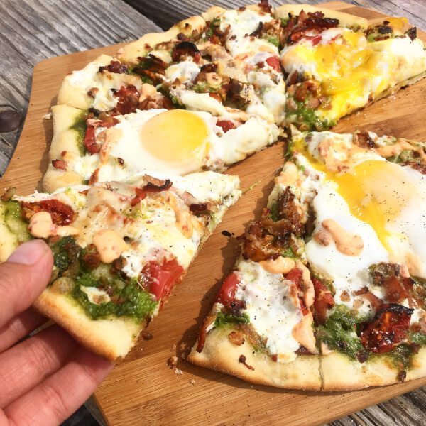 Grilled pizza on a wooden board. 