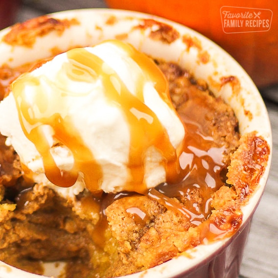 Pumpkin Cobbler Dessert in a dish with ice cream and caramel on top