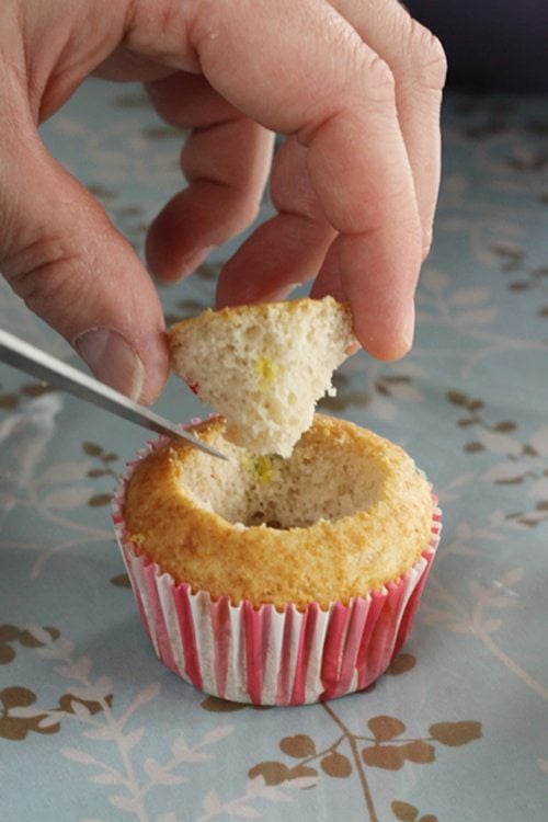 Cutting the top off of a cupcake. 