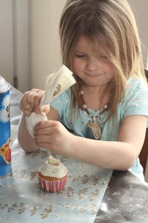 Erica's daughter frosting her cupcake. 