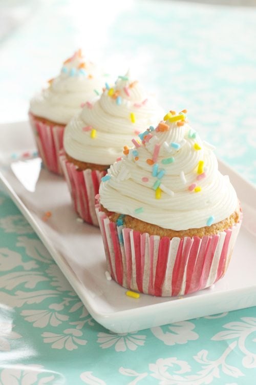 Three cupcakes on a white plate. 