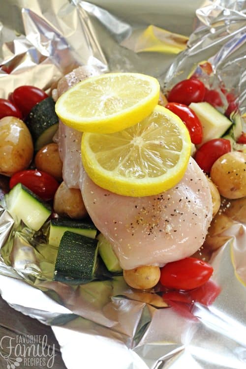 Chicken, potatoes, and veggies in aluminum foil. 