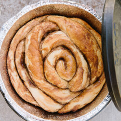 A Dutch Oven Cinnamon Roll baked in a Dutch Oven