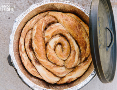 A Dutch Oven Cinnamon Roll baked in a Dutch Oven