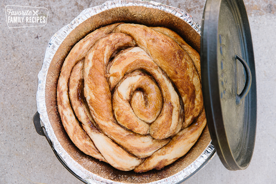 A Dutch Oven Cinnamon Roll baked in a Dutch Oven.