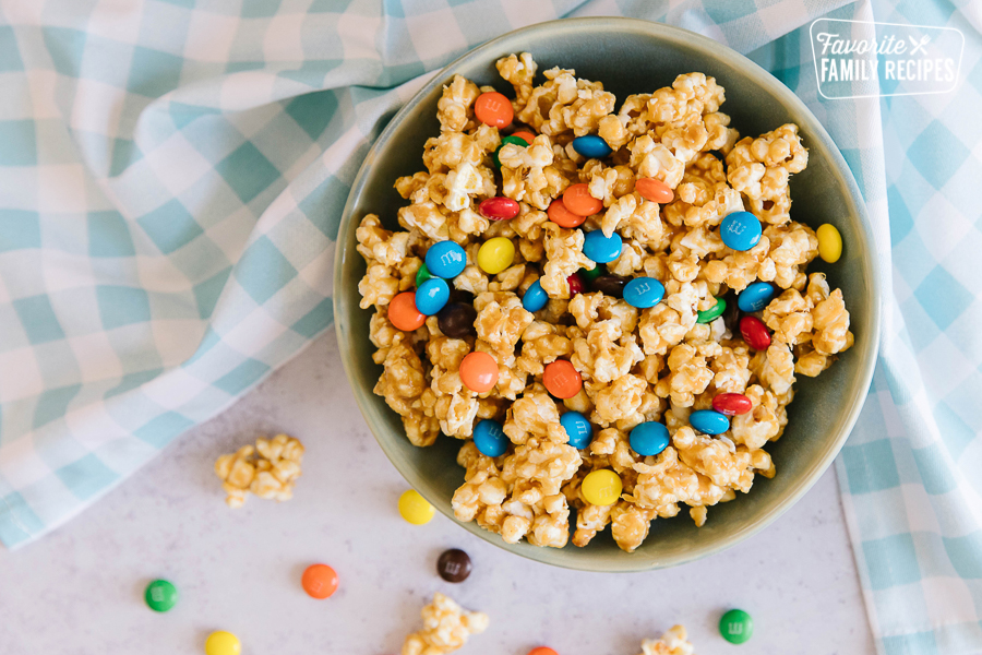 A bowl of peanut butter popcorn mixed with chocolate M&M candies