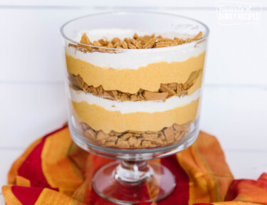 Pumpkin Trifle in a glass trifle bowl on a red napkin