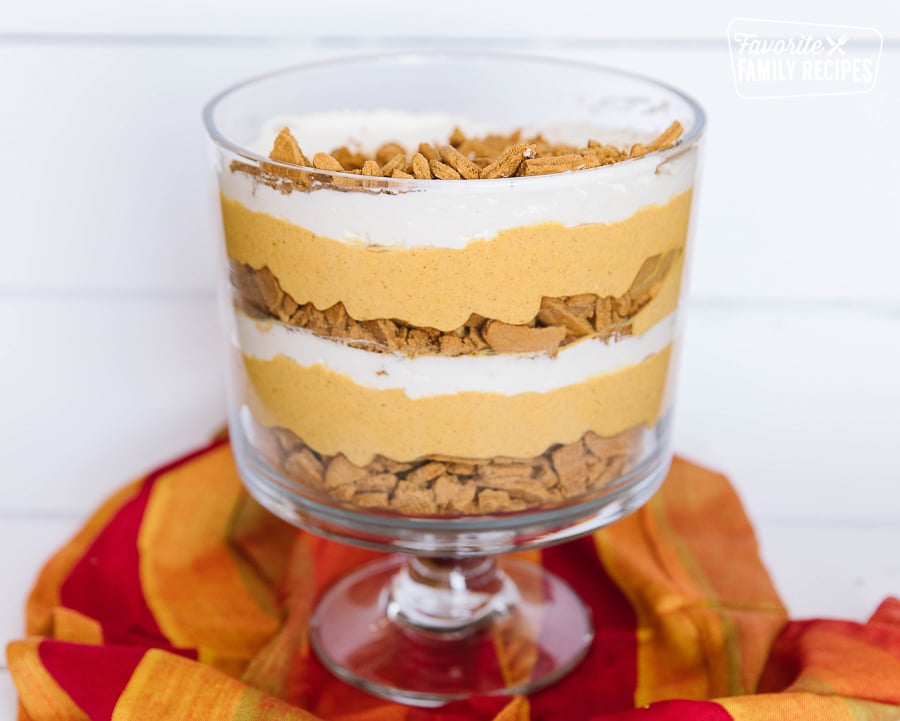 Pumpkin Trifle in a glass trifle bowl on a red napkin.