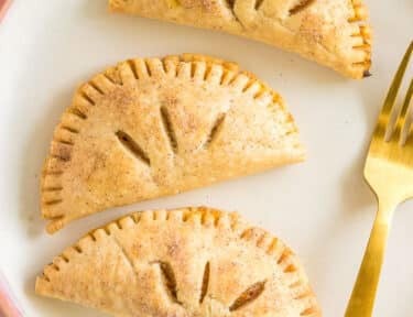 three pumpkin pasties on a plate