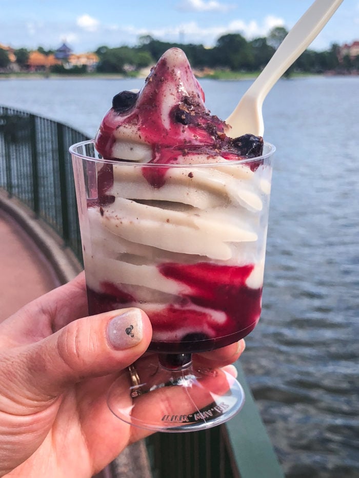 A soft serve sundae in a plastic cup. 