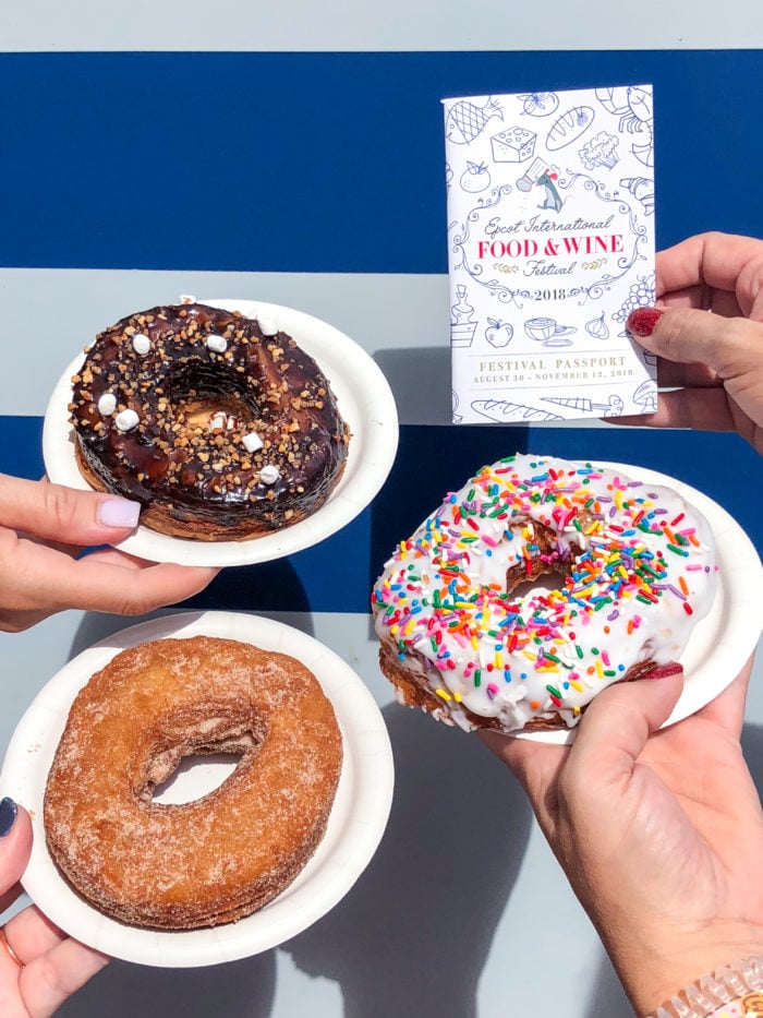 Donuts on white plates at the Food and Wine Festival. 