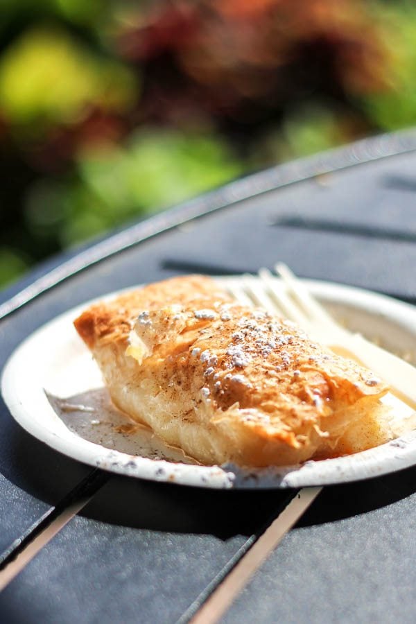 Strudel with vanilla custard on a paper plate. 