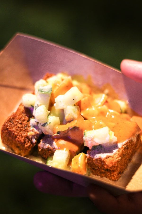 Hummus fries with tzatziki sauce in a brown bowl. 