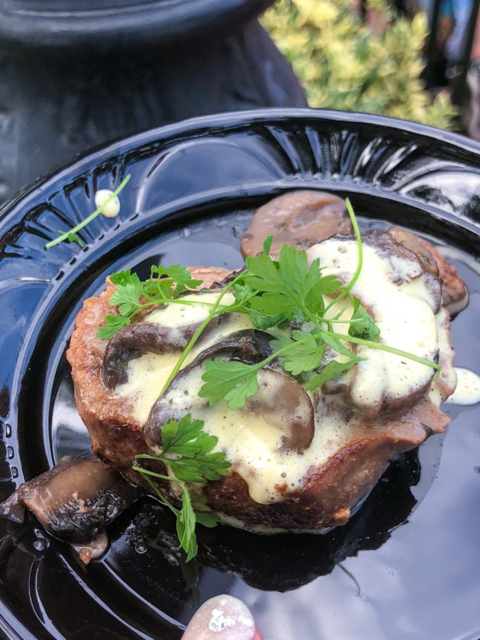 Wild mushroom mignon on a black plate. 