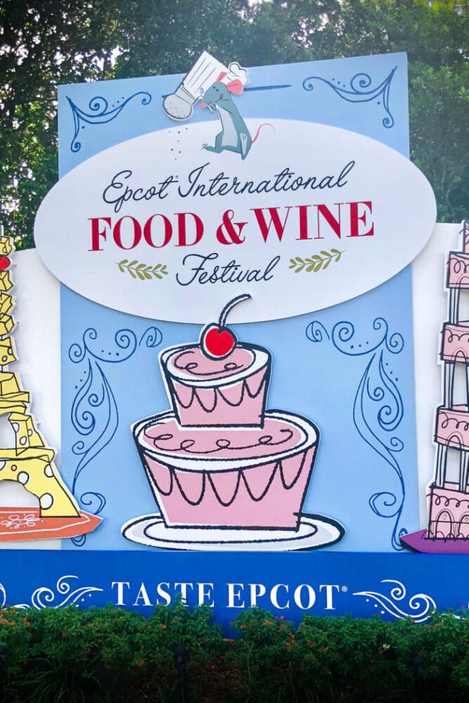Epcot International Food and Wine Festival Sign with Remy from Ratatouille sprinkling salt on the sign.