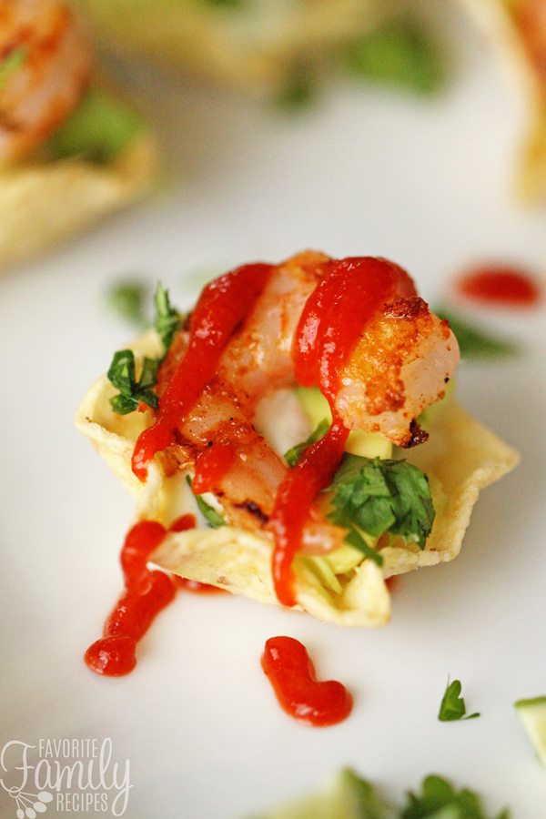A shrimp taco with sauce on top. 