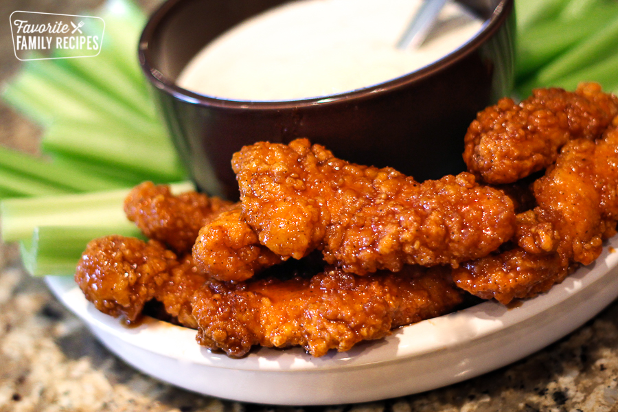 Wingers Sticky Fingers with Freakin Amazing Sauce and ranch for dipping on a serving dish