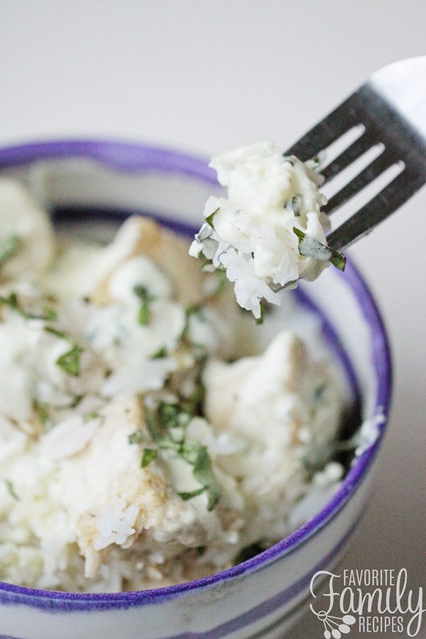 Instant Pot Chicken and Rice with Basil Cream Sauce in a bowl with a fork 