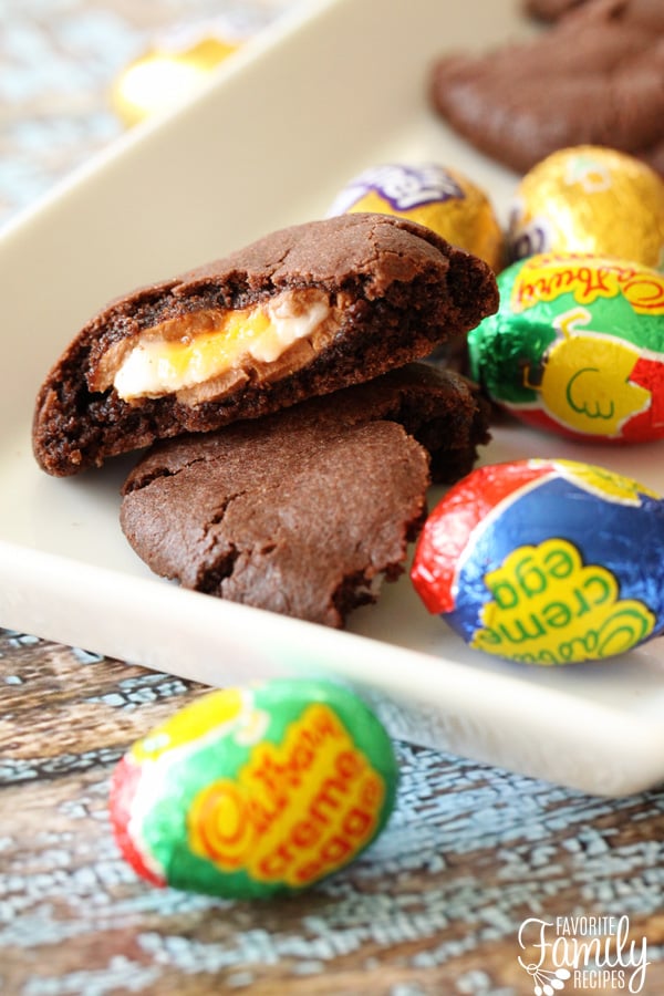 Cadbury creme Easter cookies are so rich and decadent! Fudgy cookies with a hidden surprise baked right in the center. YUM! Easter Cookies split open and placed on a white tray.