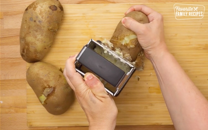Parboiled potatoes being peeled for hash browns