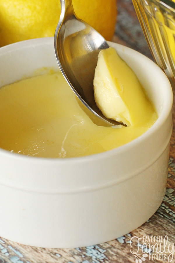 Lemon Custard being scooped from a ramekin with a spoon.