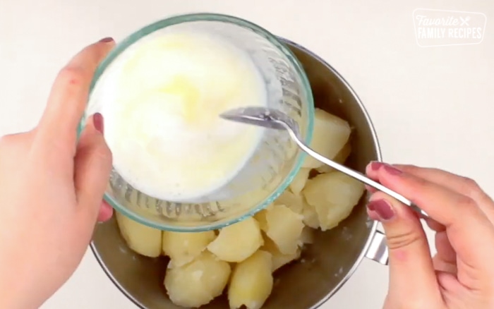 Melted butter and sour cream going into the potato.