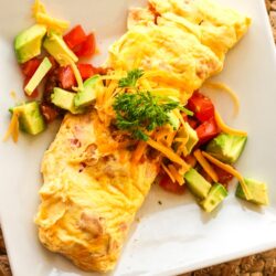 Omelette in a Bag with tomatoes, avocado, and cheese toppings