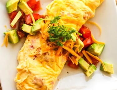 Omelette in a Bag with tomatoes, avocado, and cheese toppings