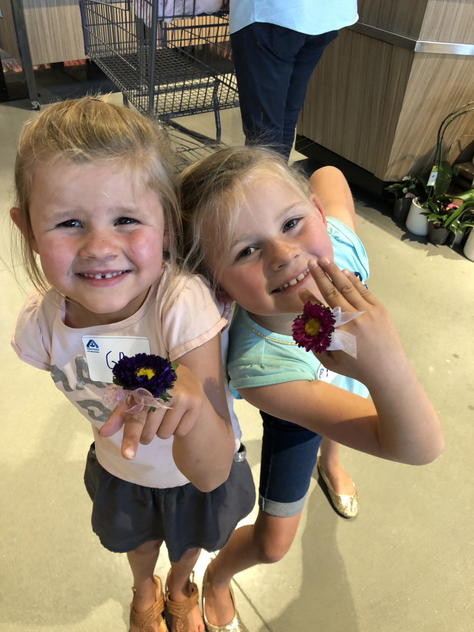 You have GOT to check out the new Albertsons on Broadway. The store is taking grocery shopping to a whole new level! Two young girls smiling with Albertsons fresh flower rings