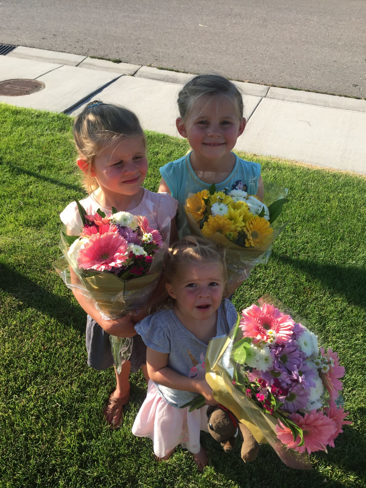 Young girls holding flower arrangements from the Albertsons grand opening in Boise