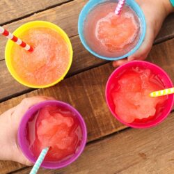 4 DIY magic slushies in rainbow colored cups with straws.