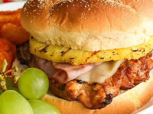 Big Kahuna Chicken Teriyaki Sandwich on a plate with a side of green grapes.