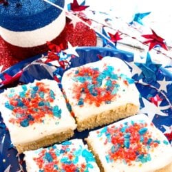 4 Firecracker Sugar Cookie Bars on a plate surrounded by fourth of july decorations.
