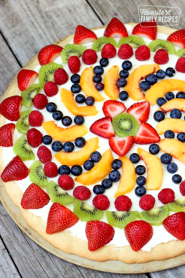 Easy Fruit Pizza decorated with strawberries, kiwi, raspberries, blueberries, and peach slices