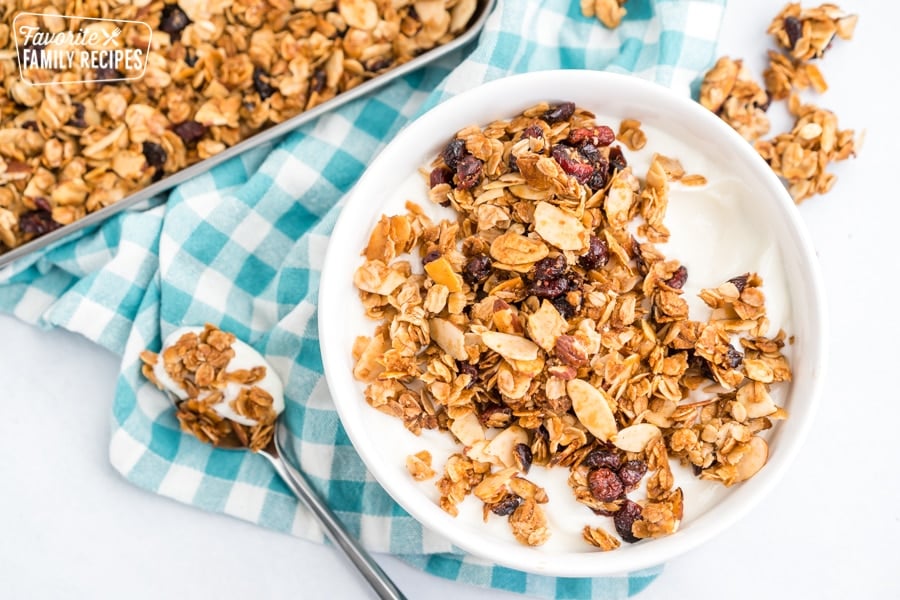 This Homemade Granola is full of oats, nuts, and dried fruit. It is much better than store-bought granolas. Serve it with milk or yogurt for a delicious breakfast. Yogurt and granola in a bowl.