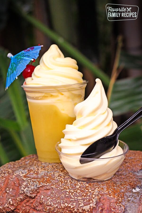 A dole whip with a spoon in front of another dole whip smoothie. 