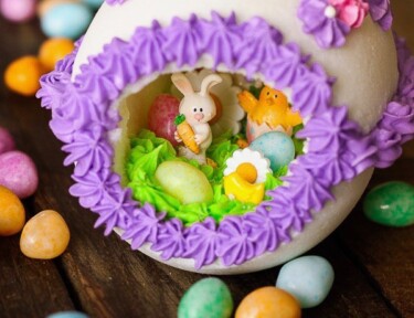 Panoramic Easter Eggs - a sugar egg decorated with frosting with miniature bunnies, chicks, flowers, and jelly beans in the center