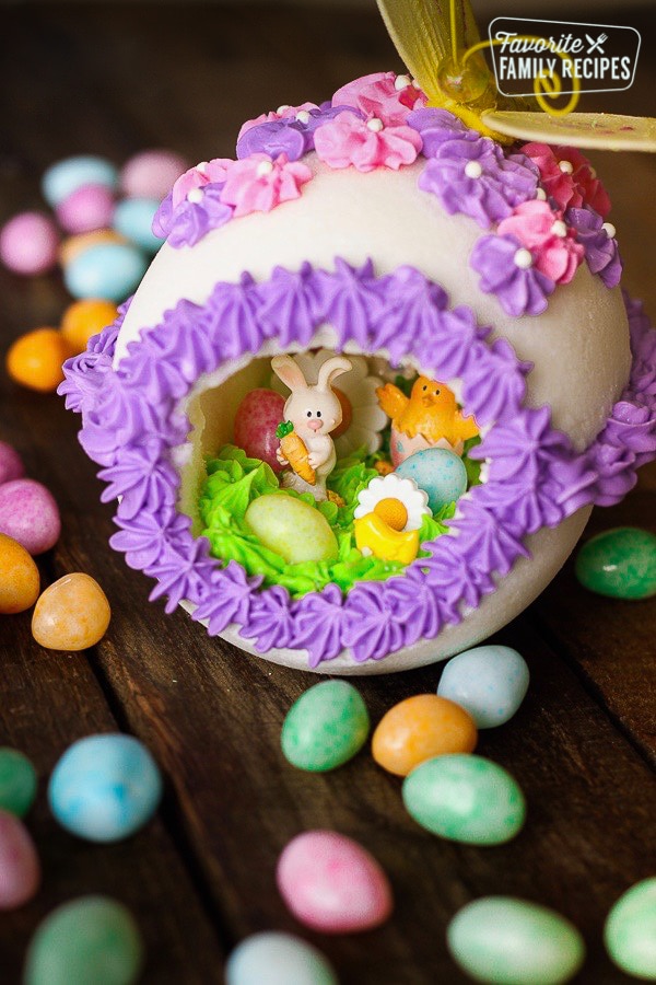 Panoramic Easter Eggs - a sugar egg decorated with frosting with miniature bunnies, chicks, flowers, and jelly beans in the center