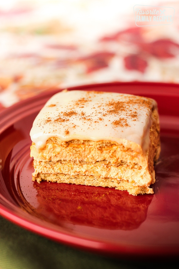 Pumpkin eclair cake on a red plate. 