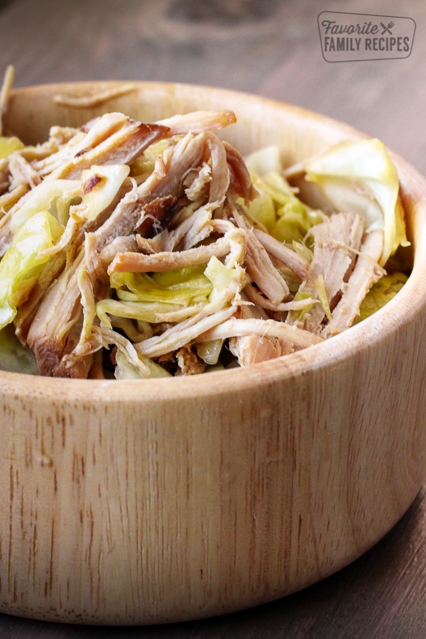 Kalua pork with cabbage in a wooden bowl.