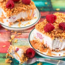Slices of white chocolate raspberry fried ice cream on two plates.