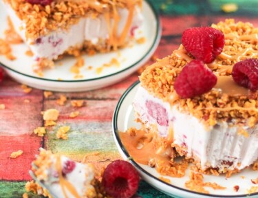 Slices of white chocolate raspberry fried ice cream on two plates.