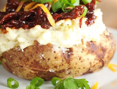 BBQ Beef Twice Baked Potato on a white plate.