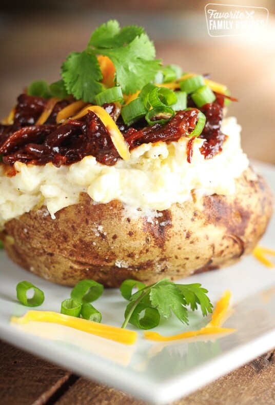 BBQ Beef Twice Baked Potato on a white plate.